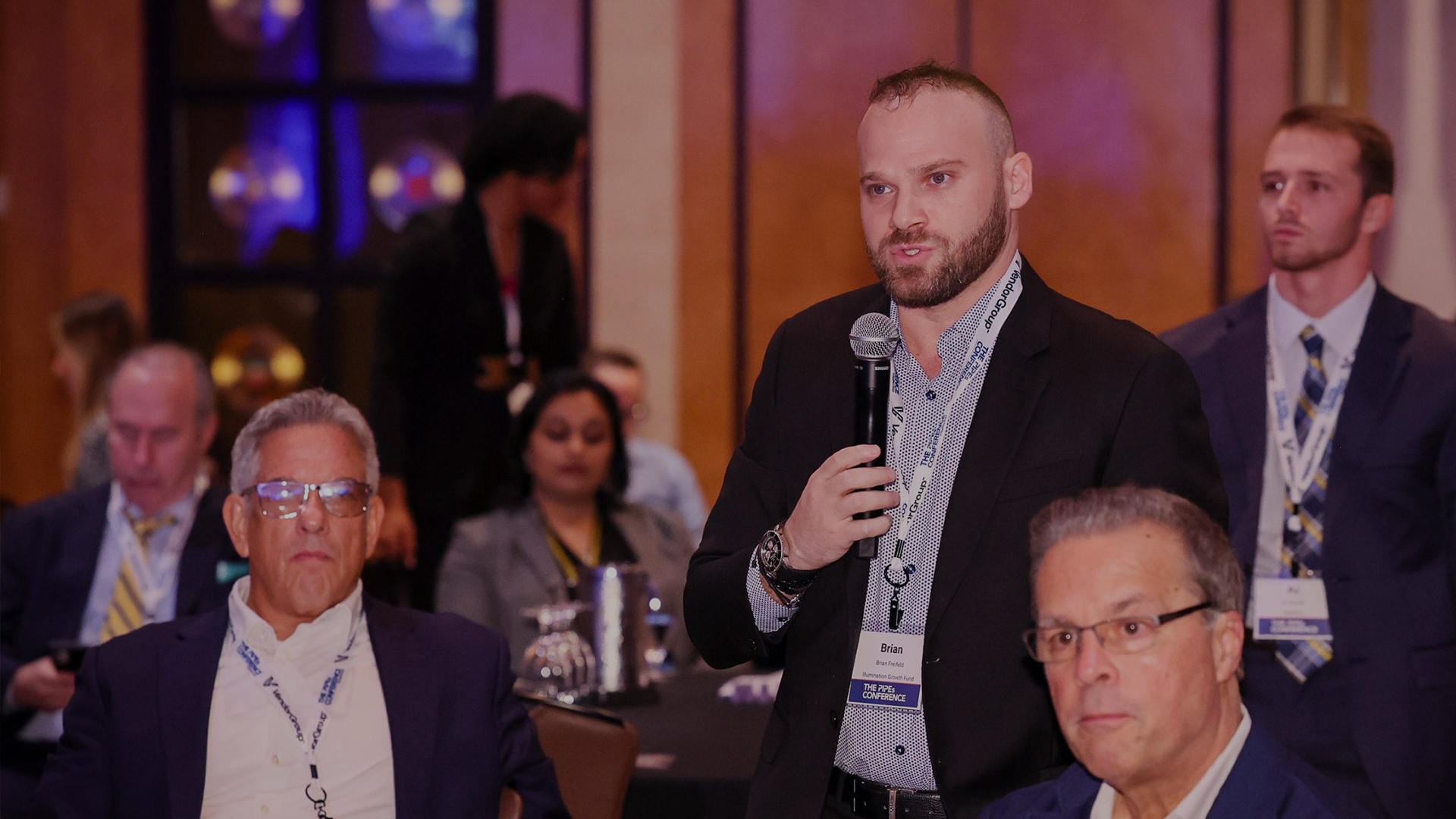 Conference attendee speaking during a session